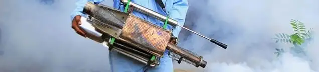 Fumigation technician using a fogger for deep pest treatment in Kansas City, MO
